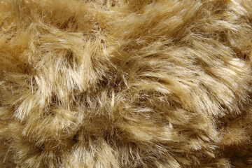 Shaggy brown faux fur plush material fabric close-up abstract textured background