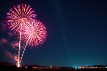 Vibrant fireworks exploding in the night sky with colorful bursts of light and sparks, nighttime, sparkles