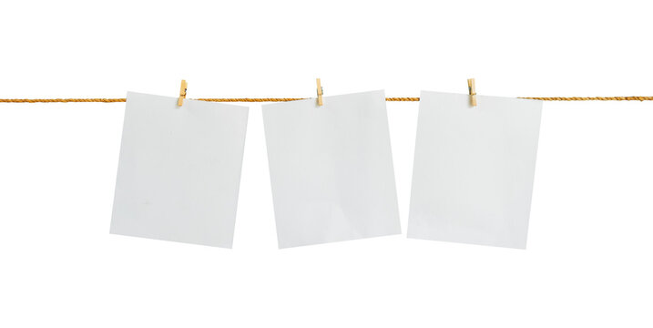 Blank paper hanging on a rope with an isolated clothespin on a white background