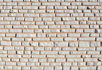 Fototapeta premium A panoramic view of a textured gray and white stone wall, ideal for backgrounds, minimal, concrete