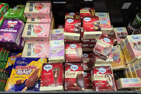 Bangsar, Malaysia &ndash; Mar 29, 2025: Selection of frozen dairy desserts including Bulla creamy classics, frozen yogurt bars, and Melona strawberry ice cream stacked in a supermarket freezer.
