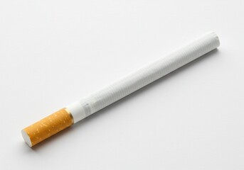 A single cigarette with a white body and brown filter on a plain white surface in close up view