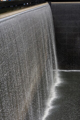 Water cascading over a straight wall.