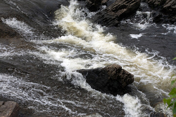 Water cascading over large boulders.