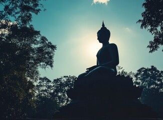 Meditating Statue Silhouette Against Sunlight in Outdoor Setting