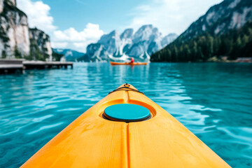 A vibrant kayak glides through crystal-clear water, surrounded by majestic mountains and lush greenery, creating a serene outdoor adventure.