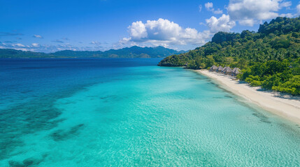 Obraz premium Serene Tropical Beach with Crystal Clear Waters and Lush Greenery Under Bright Blue Sky