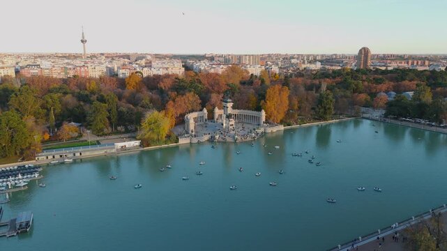 Madrid 20.11.2023. Aerial footage showcases the vibrant autumn foliage of Retiro Park in Madrid and highlights enjoyable boating on its serene lake, outdoor recreation amid the scenic cityscape