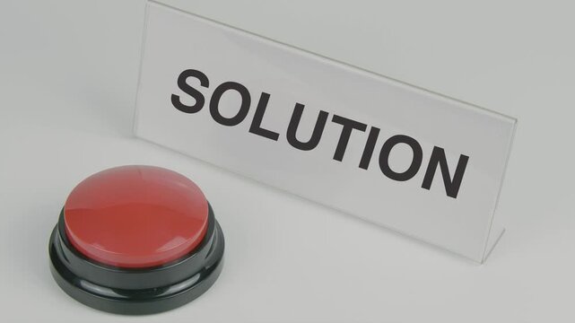 Solution text or word displayed on a nameplate as a hand presses a red button set against a white background, symbolizing resolution, innovation, or answers