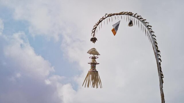 Bali, Indonesia, Penjor, a decorated bamboo pole with janur kuning, symbolizes gratitude and devotion in Balinese Hindu ceremonies, especially during Galungan.