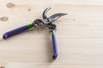 Garden pruner on the wooden workbench.
