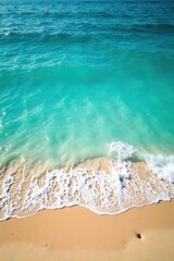 Naklejka premium Turquoise water meets ocean waves on sandy blue shore, blue, beach