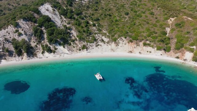 Slow panning drone shot of Filiatro beach in Ithaca island with turquoise water