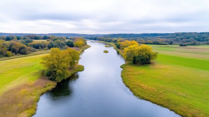 Serene river winds through autumnal landscape