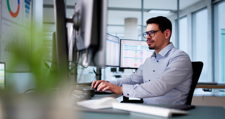 Male In The Office Audits Medical Billing Reports.