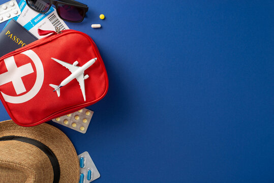 Travel setup including a first aid kit, medications, hat, and documents suggesting holiday preparation
