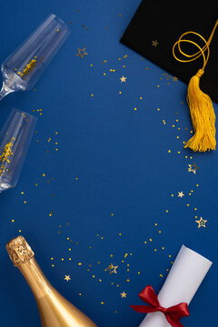 Festive vertical setup featuring a graduation cap, champagne bottle, confetti, and diploma symbolizing celebration and achievements