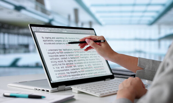 Young Woman Edits Script On Laptop