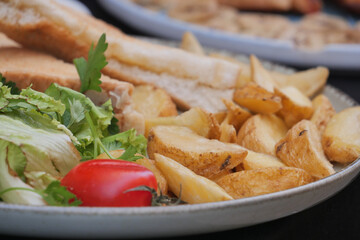 Delicious served platter of baked potatoes and fresh vegetables