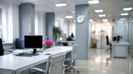Blurred open office space, filled with desks and natural light, professional