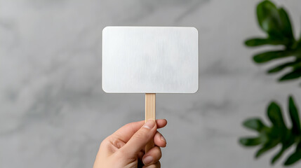 Woman's Hand Holding Blank White Banner Mockup on Wooden Stick