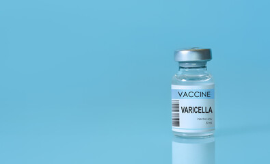 Vaccine for VARICELLA a in a bottle on a blue background. The concept of medicine, healthcare, science and vaccination awareness. Copy space. Banner
