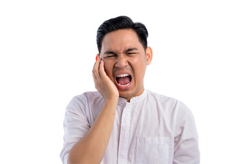 Unhealthy Asian Muslim man suffering from acute toothache, touching cheek with painful expression isolated on transparent background