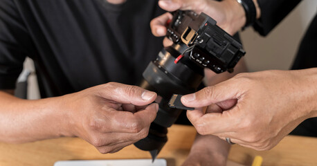 DSLR camera while working in home office. Photographers at their studio. Mature professional photographer working.