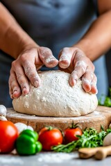 Fototapeta premium A person kneading dough on a wooden cutting board surrounded by vegetables