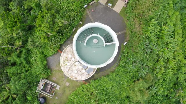 Top down, ascending drone shot of the Yokahu Tower within El Yunque National Forest in Puerto Rico