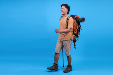 Obraz premium Full Body Side View Young Traveler Male Carry Backpack Stuff Mat Walk With Trekking Pole