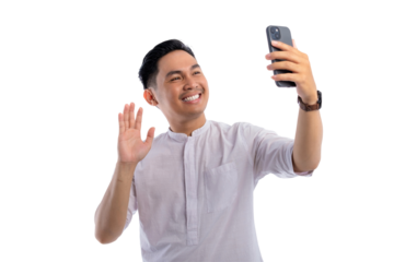 Cheerful Asian Muslim man making a video call via mobile phone isolated on transparent background