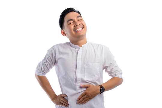 Happy Asian Muslim man touching his stomach feeling full after delicious meal with relieved expression isolated on transparent background