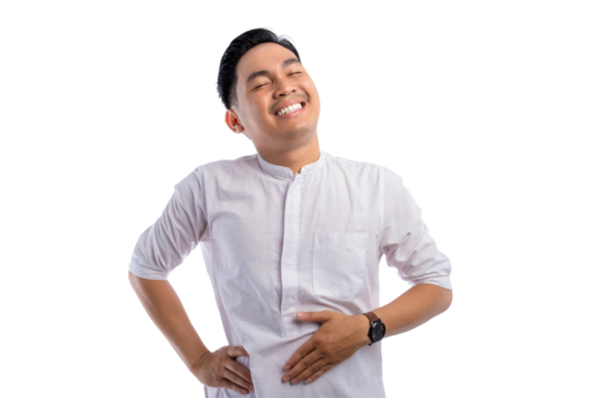 Happy Asian Muslim man touching his stomach feeling full after delicious meal with relieved expression isolated on transparent background
