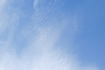 blue sky with textured white clouds