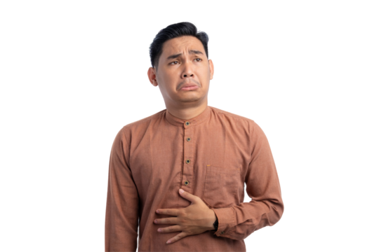 Handsome Asian Muslim man touching his stomach feels hungry and wants to eat delicious food isolated on transparent background
