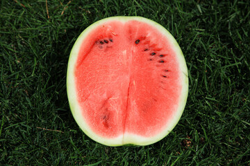 Ripe red watermelon on the grass in summer