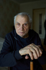 Dramatic portrait of an elderly man with intense eyes looking directly at the camera