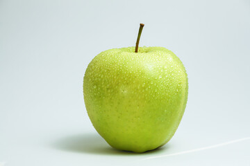 one green apple on a white background
