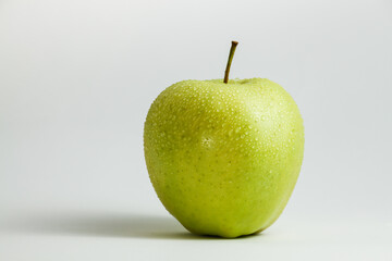 one green apple on a white background