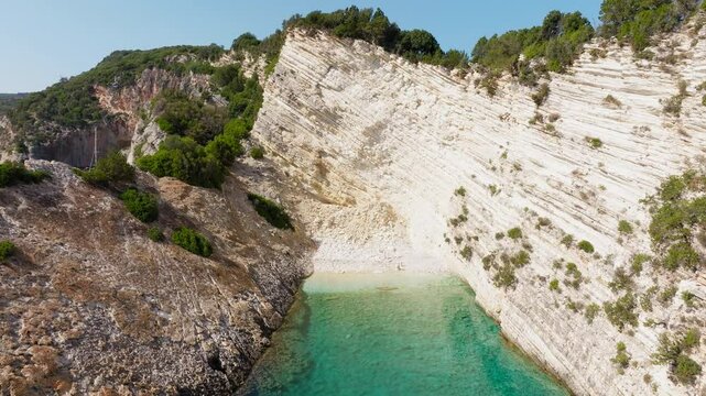 Backwards reveal drone shot of Hulla Beach on Ithaca Island, Greece