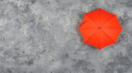 Bright Orange Umbrella on Gray Textured Surface for Visual Contrast