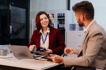 Diverse professionals collaborate on project analysis with financial graphs. Strategic teamwork and insights drive company growth and success.