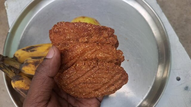 a plat of guava, banana and Thekua. It's commonly offered as prasad during the Chhath Puja festival in Bihar and other regions of India