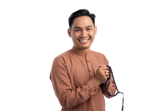 Religious Asian Muslim man holding prayer beads and smiling at camera isolated on transparent background. Ramadan and Eid Fitr celebration concept