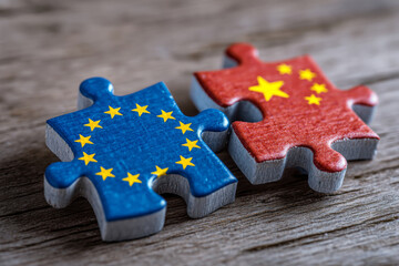 Two puzzle pieces with flags of European Union and China connected together.