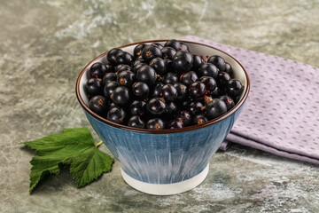 Ripe black currant in the bowl