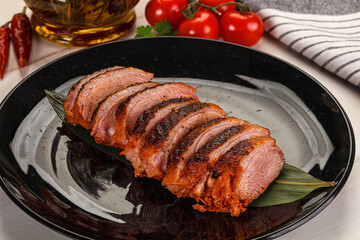 Sliced duck breast baked with cherry