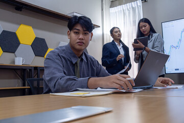 Young professionals collaborate in a modern office space during a business meeting focused on project planning and strategy