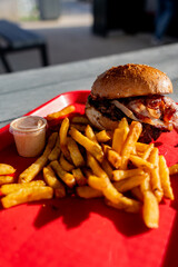 Hamburgers faits maison au fromage fondant et au bacon, accompagnés de frites croustillantes et de...